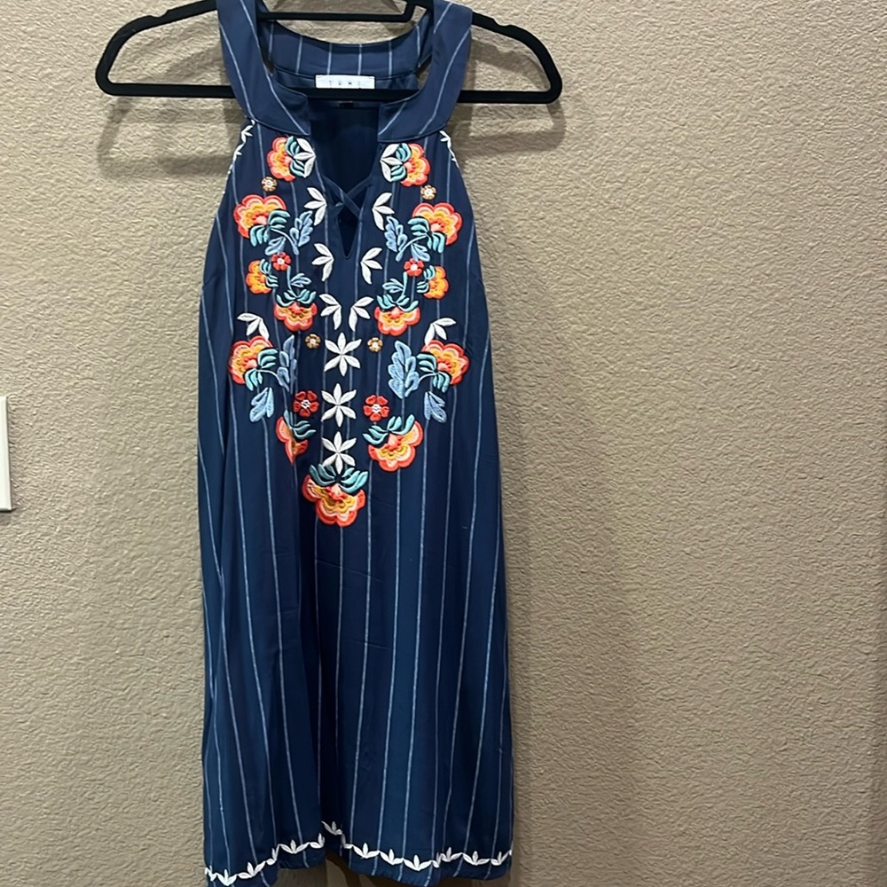 Navy blue dress with pinstripes and embroidered flowers.